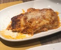 Homemade meat lasagna. Copy space for text, top view. A piece of tasty hot lasagna served with a piece of anchovy and salmon on a Royalty Free Stock Photo