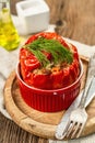 Homemade meat and rice stuffed bell peppers. Olive oil, sauce, cutlery on vintage wooden background Royalty Free Stock Photo