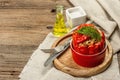 Homemade meat and rice stuffed bell peppers. Olive oil, sauce, cutlery on vintage wooden background Royalty Free Stock Photo