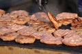 Homemade meatballs on an electrical grill. Grill background. Fast foot outside. Diet and health. Minced meat on barbecue. Pleskav Royalty Free Stock Photo