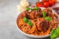 Homemade meatballs with pasta spaghetti, tomato sauce, parmesan cheese and basil on concrete background Royalty Free Stock Photo