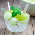 Homemade melon popsicles in the glass, closeup, square format