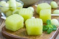 Homemade melon popsicles on a wooden background