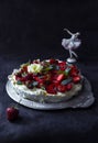 Homemade meringue cake Anna Pavlova with straeberries and mint on the dark background. Copy space