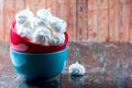 Homemade Meringue in a cup on the wooden table.