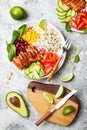 Homemade Mexican chicken burrito bowl with rice, beans, corn, tomato, avocado, spinach. Taco salad lunch bowl. Royalty Free Stock Photo