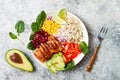 Homemade Mexican chicken burrito bowl with rice, beans, corn, tomato, avocado, spinach. Taco salad lunch bowl. Royalty Free Stock Photo