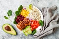 Homemade Mexican chicken burrito bowl with rice, beans, corn, tomato, avocado, spinach. Taco salad lunch bowl. Royalty Free Stock Photo