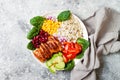 Homemade Mexican chicken burrito bowl with rice, beans, corn, tomato, avocado, spinach. Taco salad lunch bowl. Royalty Free Stock Photo