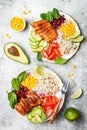 Homemade Mexican chicken burrito bowl with rice, beans, corn, tomato, avocado, spinach. Taco salad lunch bowl. Royalty Free Stock Photo