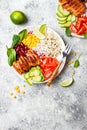 Homemade Mexican chicken burrito bowl with rice, beans, corn, tomato, avocado, spinach. Taco salad lunch bowl. Royalty Free Stock Photo