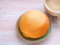 Homemade mexican vanilla bun (coffee bun) on turquoise clay round plate. Royalty Free Stock Photo