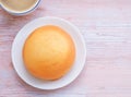 Homemade mexican vanilla bun (coffee bun) on white plate and coffee cup over rustic table. Royalty Free Stock Photo