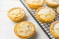Homemade mince pies. Traditional British Christmas pastry dessert with apples raisins nuts filling on metal cooling rack Royalty Free Stock Photo