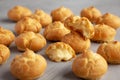 Homemade Mini Cream Puffs on a gray background, side view