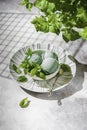Homemade mint ice cream with mint leaves on a concrete background.