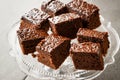 Homemade Moist Chocolate Sponge Cake Brownie Pieces in Vintage Glass Dessert Stand. Royalty Free Stock Photo