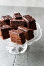 Homemade Moist Chocolate Sponge Cake Brownie Pieces in Vintage Glass Dessert Stand. Royalty Free Stock Photo