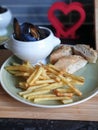 Homemade moules  frites,  chips, French fries, ciabatta bread  and mussels cooked in cream, garlic and white wine Royalty Free Stock Photo