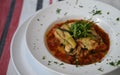 Home made food photography of a mediterranean cooked and served moussaka dish in a white bowl