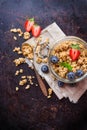 Homemade muesli granola in a jar on rusty black table