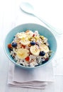 Homemade muesli topped with fruit and buts