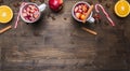 Homemade mulled wine with apple, orange, cinnamon, cloves and other ingredients have been laid out around a wooden rustic backg