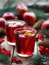 Homemade mulled wine or sangria with orange and apple slices , cranberries, cinnamon. Christmas tree decorations