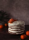 homemade multi-layered high chocolate cake with white cream and tangerines