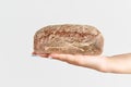 Homemade multigrain bread in woman hand over white background