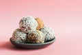 Homemade energy dates balls on pink background. Space for text