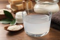 Homemade natural rice water and cosmetic products on wooden table, closeup