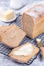 Homemade no knead sandwich bread with butter, on cooling rack, vertical Royalty Free Stock Photo