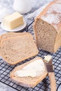 Homemade no knead sandwich bread with butter, on cooling rack, vertical Royalty Free Stock Photo