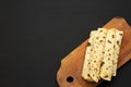 Homemade Norwegian Potato Flatbread Lefse with Butter and Sugar on a rustic wooden board on a black background, top view. Copy