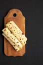 Homemade Norwegian Potato Flatbread Lefse with Butter and Sugar on a rustic wooden board on a black background, top view. Space