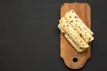 Homemade Norwegian Potato Flatbread Lefse with Butter and Sugar on a rustic wooden board on a black surface, top view. Overhead