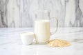 homemade oat milk in a glass pitcher on a marble slab Royalty Free Stock Photo