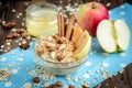 Homemade oatmeal with apple, cinnamon, hazelnuts, honey and peanuts on dark wooden background Royalty Free Stock Photo
