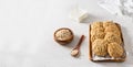 Homemade oatmeal cookies with banana, oats and nuts on a wooden tray and oats flakes on white background, side view, copy space. Royalty Free Stock Photo