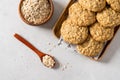 Homemade oatmeal cookies with banana, oats and nuts on a wooden tray and oats flakes on white background, top view, close up. Royalty Free Stock Photo