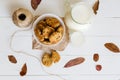 Homemade oatmeal cookies with raisins and prunes with jug and glass of milk on white wooden background. No sugar, no flour Royalty Free Stock Photo