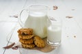 Homemade oatmeal cookies with raisins and prunes with jug and glass of milk on white wooden background. No sugar, no flour Royalty Free Stock Photo