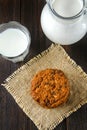 Homemade oatmeal cookies. A stack of cookies on burlap on a brown wooden table. Milk in the background. Royalty Free Stock Photo