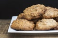 Homemade oatmeal cookies in white square plate,on wooden board and Black background. Sweet dessert snack, Healthy Food. Copy space Royalty Free Stock Photo