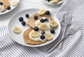 Homemade oatmeal pancakes with yogurt, fresh blueberry and banana at white wooden background Royalty Free Stock Photo