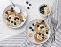 Homemade oatmeal pancakes with yogurt, fresh blueberry and banana at white wooden background Royalty Free Stock Photo