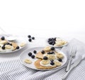 Homemade oatmeal pancakes with yogurt, fresh blueberry and banana at white wooden background Royalty Free Stock Photo