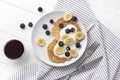 Homemade oatmeal pancakes with yogurt, fresh blueberry and banana at white wooden background Royalty Free Stock Photo