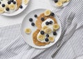 Homemade oatmeal pancakes with yogurt, fresh blueberry and banana at white wooden background Royalty Free Stock Photo